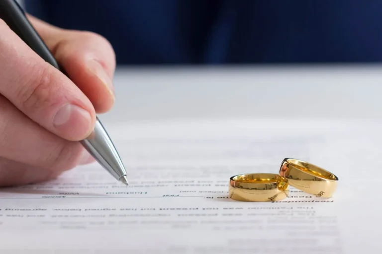 divorce attorney in Mesa helping clients sign legal divorce agreement